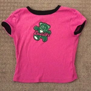 This is an H&M shirt printed with a teddy bear that says cuddles. Women’s Small.